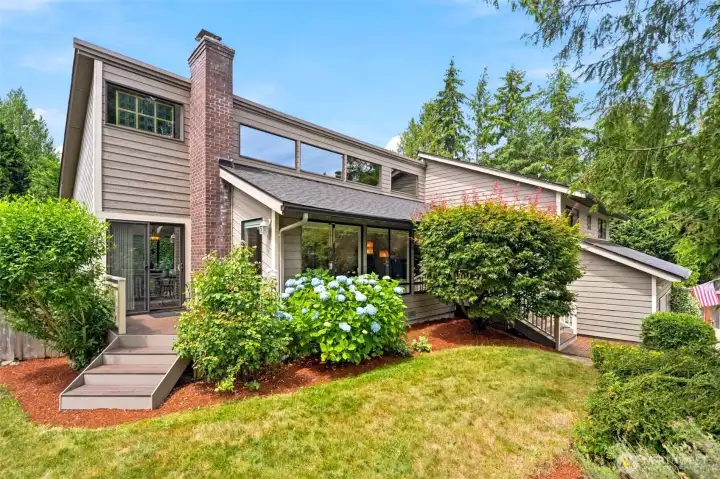 Striking exterior showcasing expansive windows & private deck spaces