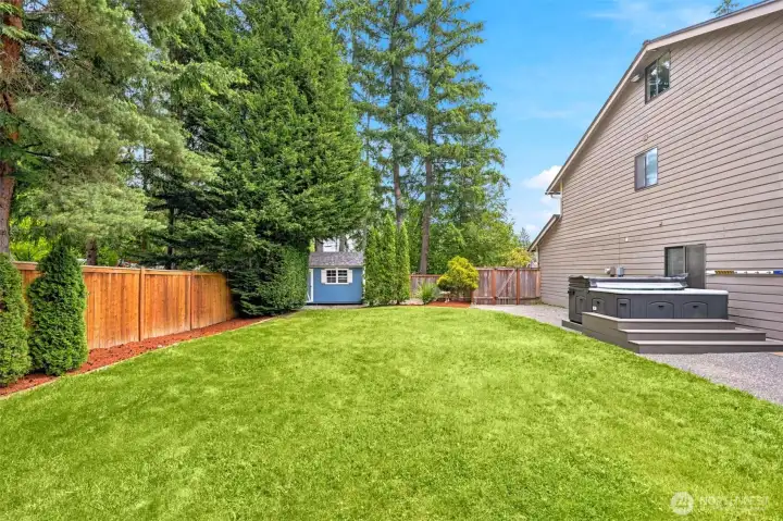 Expansive backyard with outbuilding & mature landscaping