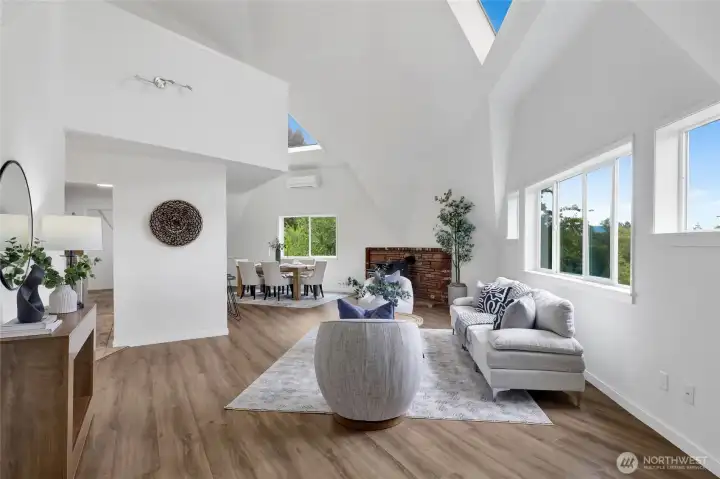Dramatic living room with soaring vaulted ceilings, creating an open, spacious, and inviting atmosphere. Dramatic living room with soaring vaulted ceilings, creating an open, spacious, and inviting atmosphere.