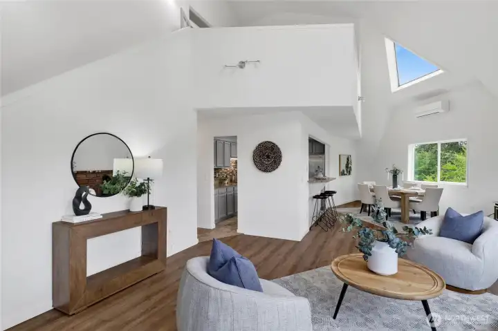 Spacious living room featuring vaulted ceilings that enhance the home’s unique architecture and open-concept feel. Spacious living room featuring vaulted ceilings that enhance the home’s unique architecture and open-concept feel.