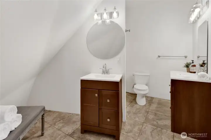 Private ensuite full bathroom serving the upper-level primary suite, offering comfort, convenience, and everyday functionality. Private ensuite full bathroom serving the upper-level primary suite, offering comfort, convenience, and everyday functionality.