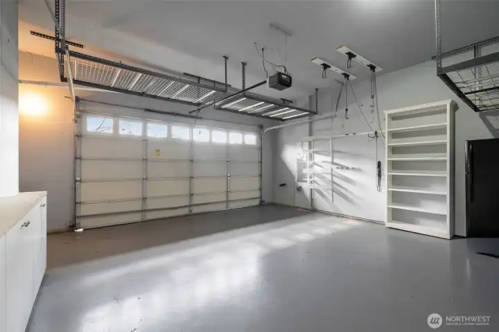 Plenty of overhead storage, built-in cabinets, and bike racks line this pristine garage with 2nd fridge & portable generator Plenty of overhead storage, built-in cabinets, and bike racks line this pristine garage with 2nd fridge & portable generator