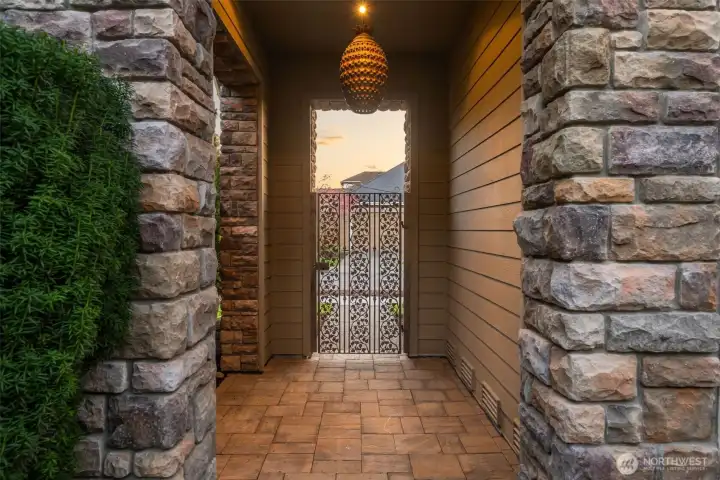 Sophisticated & stylish gated entry, with cultured stone posts, & concrete pavers Sophisticated & stylish gated entry, with cultured stone posts, & concrete pavers