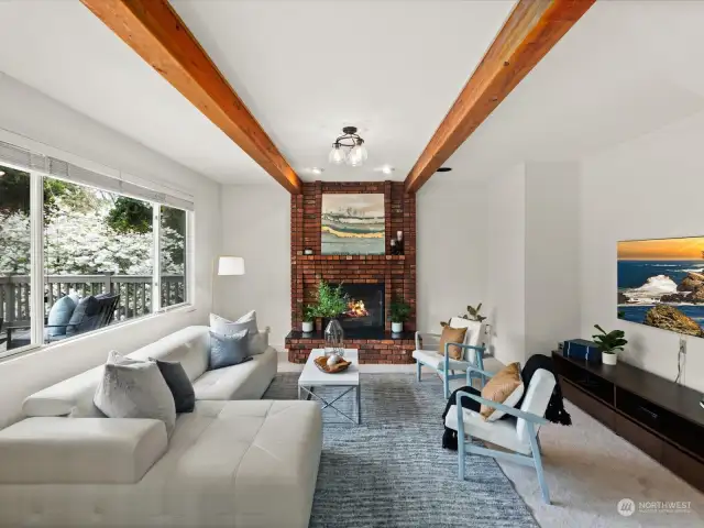 Cozy family room with exposed beams and wood burning fireplace