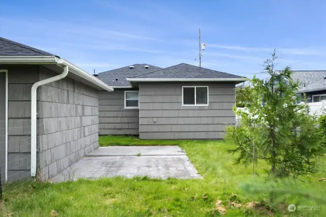 Fenced back yard with fruit trees.