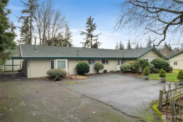 Plenty of parking with carport and extra storage building