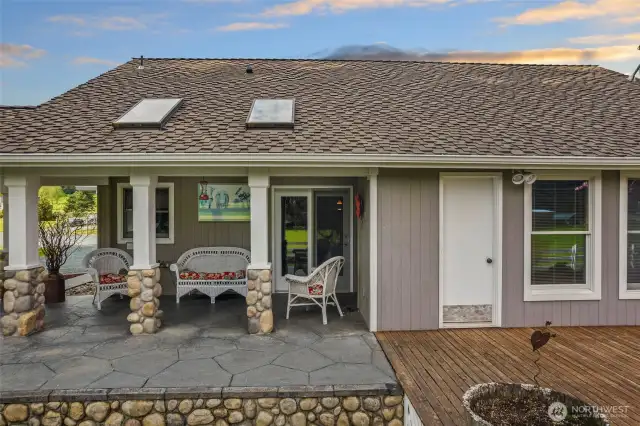 Covered patio area on south side of home with skylights and stamped concrete.
