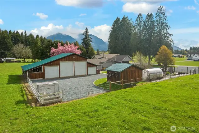 Spacious 4 Bay 2126 sqft shop/garage/barn has room for all your toys and projects. East side opens to pasture with stalls for horses or other farm animals. Water hydrants on 3 fenced areas of pasture for easy watering. The small building next to the greenhouse is the pump house /canning room is fully finished with heat holds, water softener, stainless steel sink for processing fruit, veggies, fish & meat.