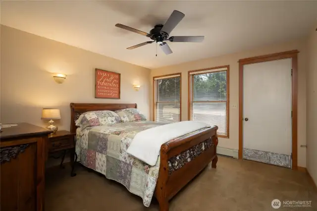 Primary bedroom on main floor with access to deck with hot tub.