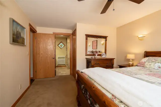 Primary bedroom looking towards in suite bathroom and large closet.