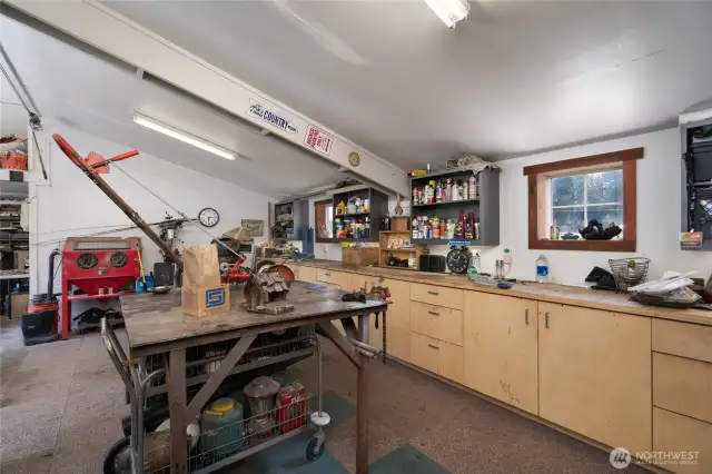 Inside the Large heated shop with custom workbench/cabinets and easy pull drawers. Great space for projects with compressed air throughout, engine hoist and more.