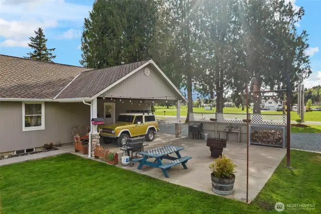 Back porch & carport with sports slab with basketball hoop. Outdoor lighting on switch.