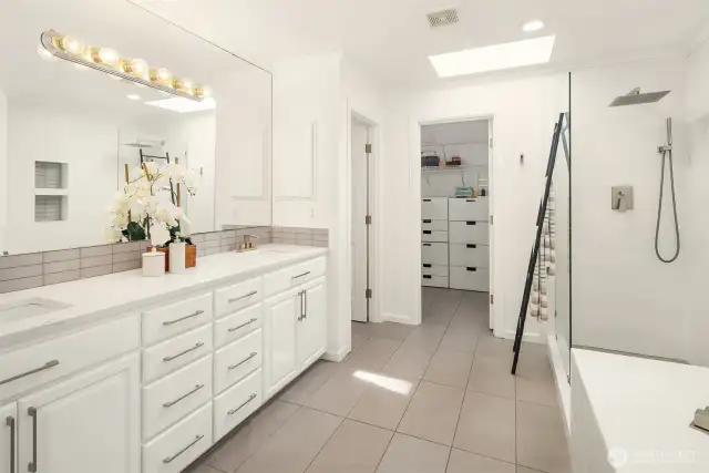 Updated five piece primary bathroom with large walk in show and built in closet system.