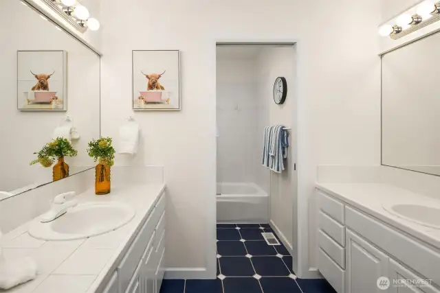 Refreshed family bathroom with double vanities and separate shower and WC for optimal convenience