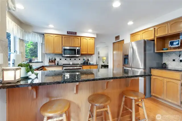 Kitchen includes an eating bar area perfect for casual dining and visiting with guests.