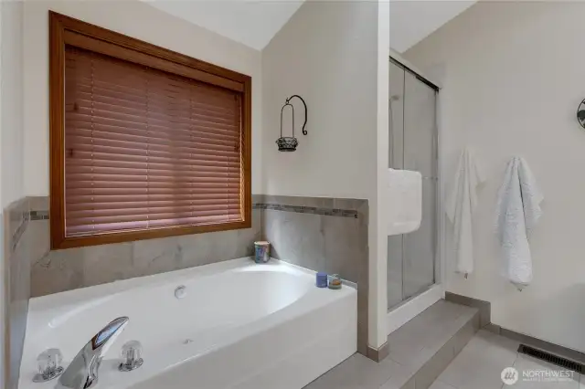 Primary bathroom with a soaking tub and separate shower, luxury tile to include heated floors for your comfort.