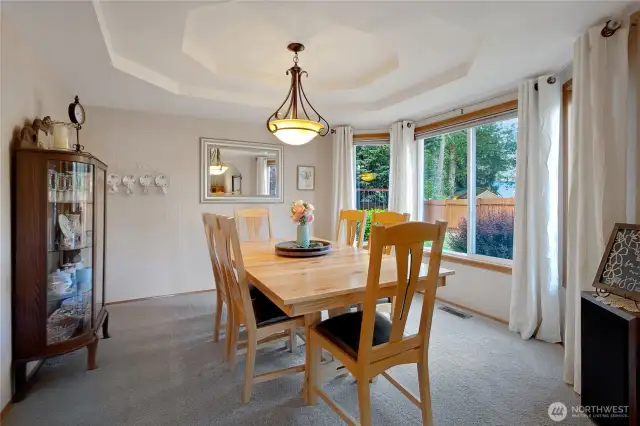 Situated between the kitchen and living rooms, the dining room showcases a large window overlooking the stunning backyard and offers an inviting space perfect for entertaining.