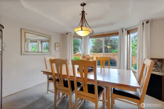 Situated between the kitchen and living rooms, the dining room showcases a large window overlooking the stunning backyard and offers an inviting space perfect for entertaining.