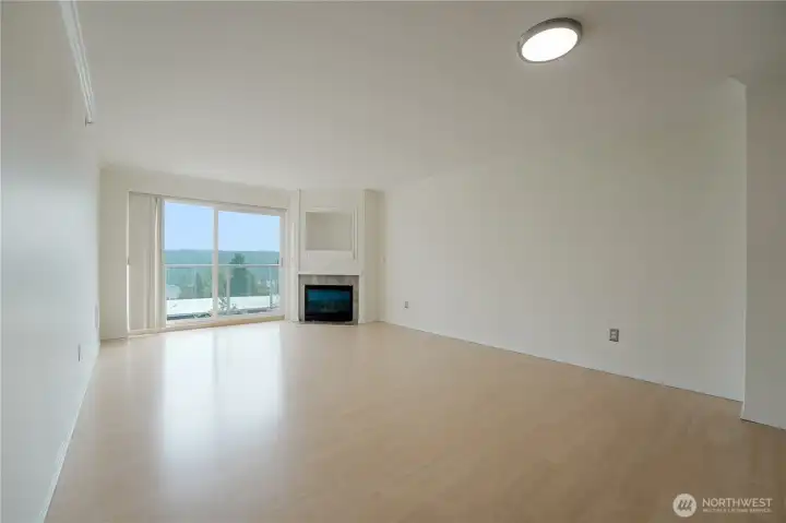 The Light and Bright Great Room has a Gas Fireplace and Sliders Out to the View Deck