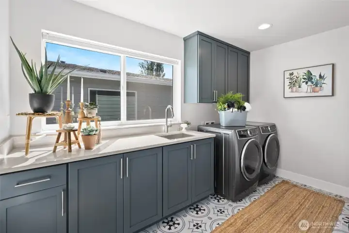 Laundry room with counter and sink upstairs.