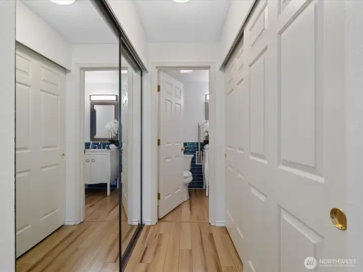 Double closets lead to the primary bath. This home has more than generous storage space.