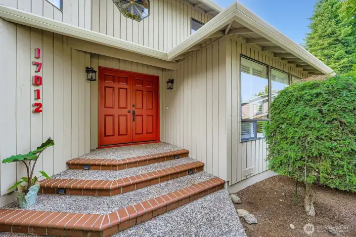 The fresh exterior paint and the covered tile & aggregate front entry are welcoming features when arriving home.