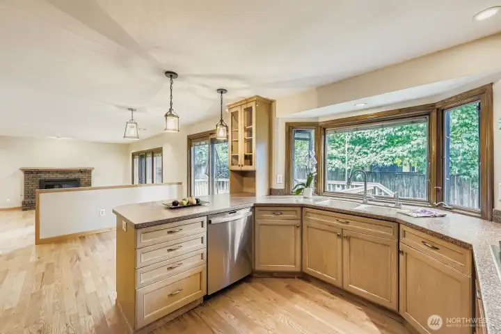 The spacious kitchen continues into the breakfast area and one step down to the family room. Both rooms have Pella sliding doors that access the deck and backyard.