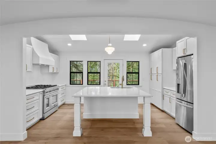 48" Range, coved counters, skylights, large deck! What a great spot to entertain!