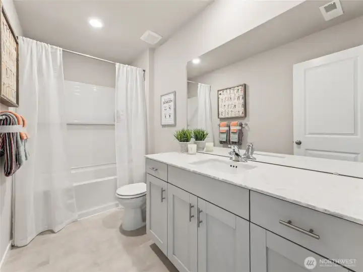 Upstairs hall bathroom with deep tub and shower.  Finishes and options may vary.