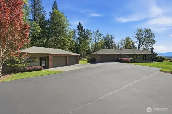 A Stunning Custom Rambler, w Cedar Siding & a Tile Roof.   Plus, a separate Auxiliary Apartment w 1 Bedroom, a luxurious 3/4 Bathroom & a Kitchenette & 2 car Shop/Garage, ideal for a Home Office or re-design as a full Shop.