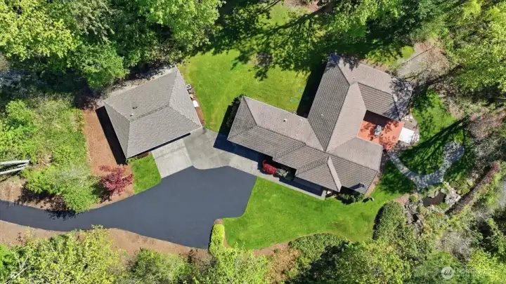 The main house has a tile roof, and the "Auxiliary" space has a composition roof.   Check out All of the parking!