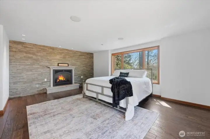 The Primary Retreat ~ The Cozy Gas Fireplace w Jura Beige Limestone is a welcomed feature.
