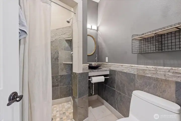 The Office ( ADU) 3/4  Bath has Granite Counters, a Glass Sink, Slate~ Porcelain & Travertine Shower & Wainscot.