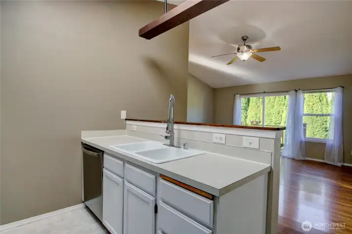 Open concept kitchen with the dining and living area. Oversized windows keep the area bright.