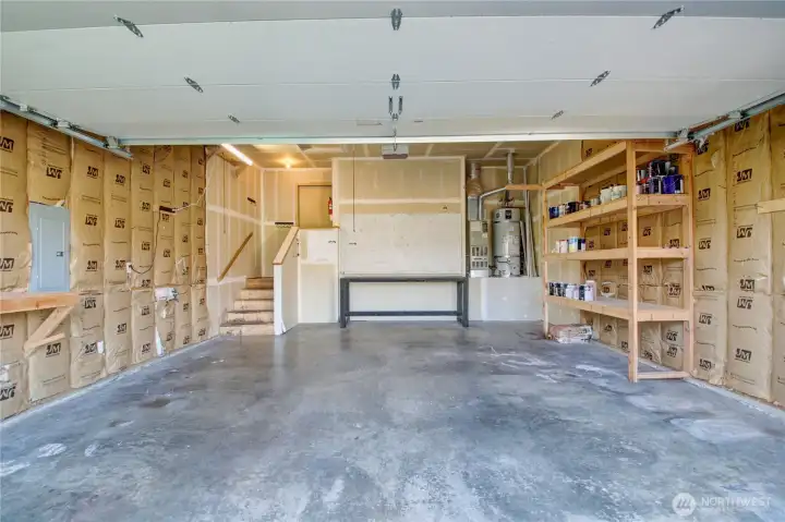 An insulated oversized 2 car garage with storage and work benches.  Furnace and new hot water tank are easily accessible.