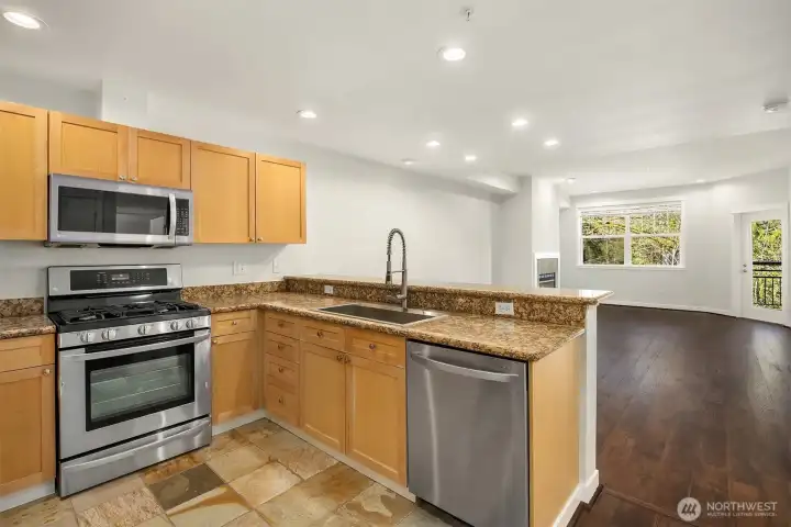 Open and inviting floorplan unfolds with newer flooring.