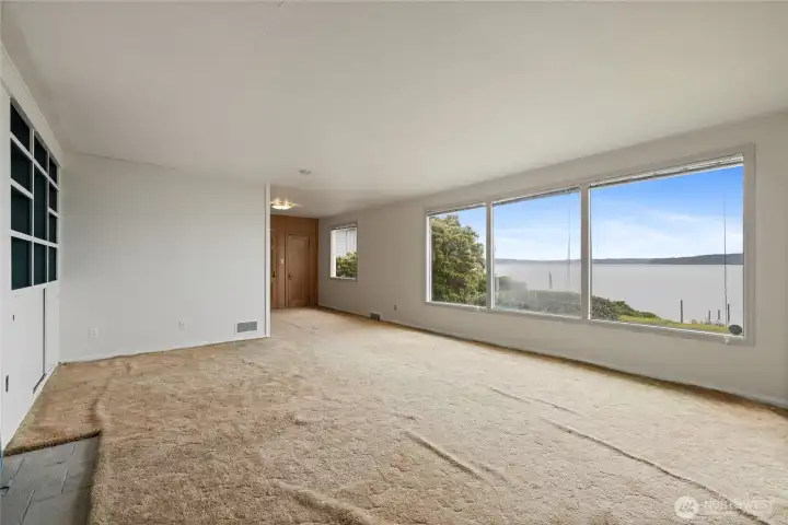 Huge living room with tons of windows to watch the water