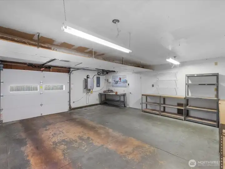 Spacious garage with work bench and shelving