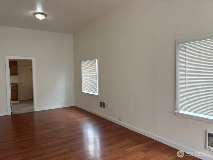 Living room looking toward the kitchen. Mini blinds on all windows. Living room looking toward the kitchen. Mini blinds on all windows.