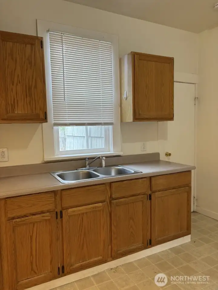 Kitchen has a window looking out toward the back yard and garage. Kitchen has a window looking out toward the back yard and garage.