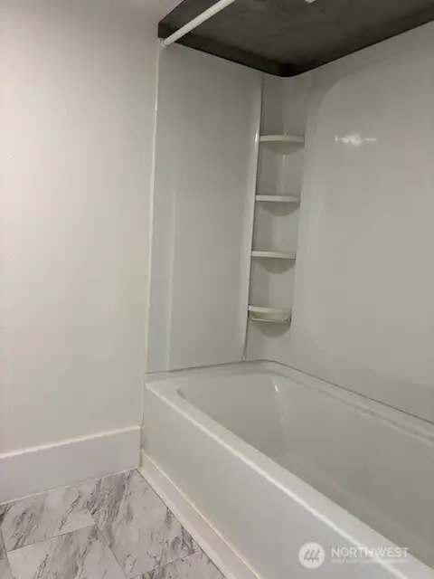 Remodeled bathroom has a shower over the tub Remodeled bathroom has a shower over the tub