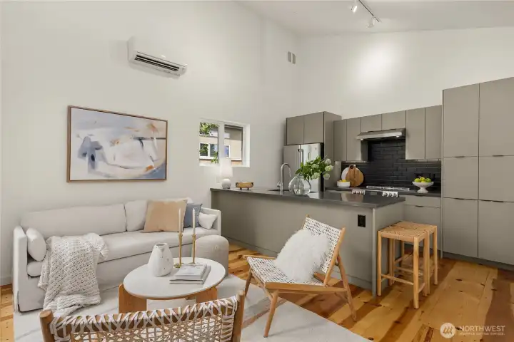 The neutral color palette of the kitchen juxtaposed against the warmth of the top-nailed pine floors is so unique…and just plain cool. Speaking of cool, note the ductless mini-split heat pump for efficient and effective cooling and heating.