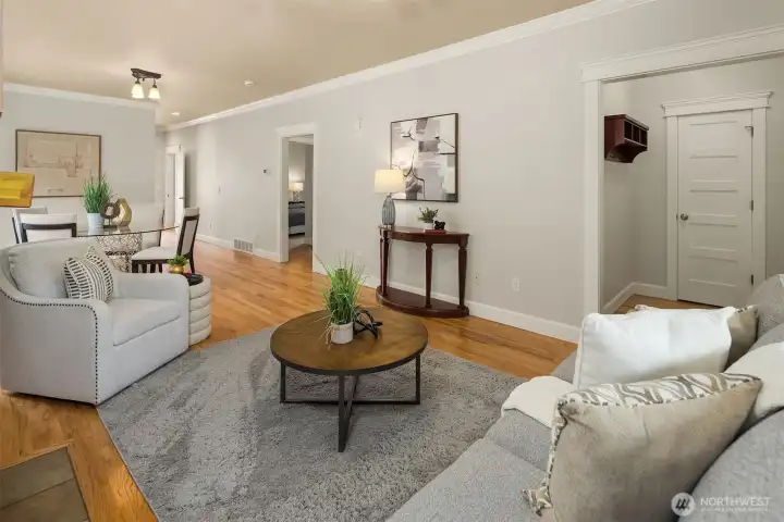 The living room flows seamlessly to the dining room. Don't miss the dedicated entry with coat closet to the left.