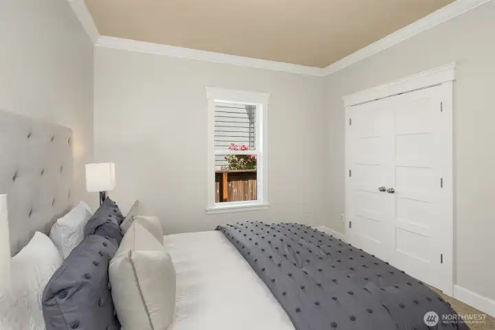 The second main-level bedroom also with new paint and crown molding.