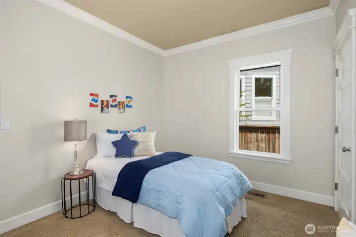 The second main-level bedroom also with new paint and crown molding.