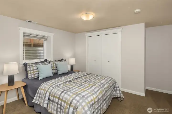 The first of two lower level bedrooms. Both rooms have fresh paint, good natural light, generous closet space, and a large window.