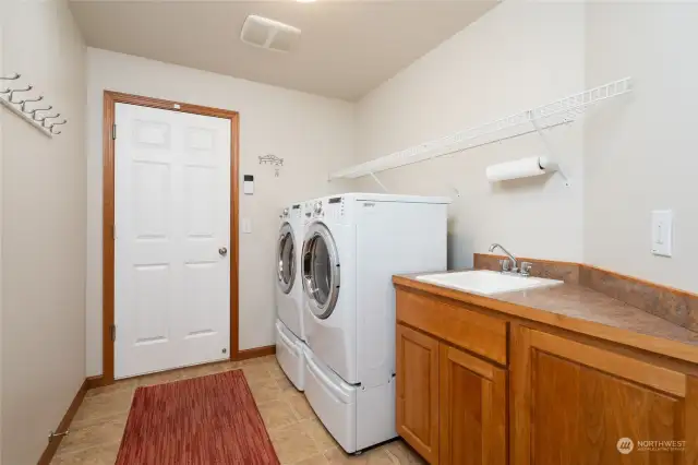 Laundry/Mud Room with Laundry Sink and storage.  The door here leads out to your 3 car garage with work benches, cabinets and tons of space!  The Garage/Electrical Panel is wired for generator (powers well pump and everything except Heat pump & Dryer)