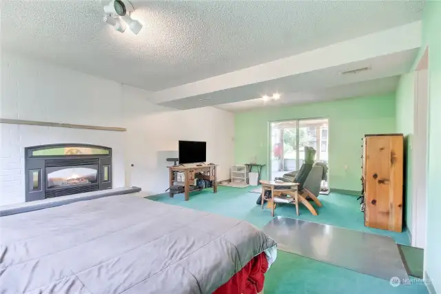 Cozy gas fireplace in family room, rec room, bedroom with view and access to private backyard.