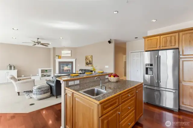 Note the chic stainless steel French door fridge with a bottom freezer and convenient water/ice dispenser, it has everything you need at your fingertips. With upper cabinets for extra storage, you’ll never run out of space. As you whip up your favorite meals, enjoy the open view into the family room, perfect for keeping the conversations flowing. And don’t forget the practical storage closet nearby—ideal for keeping everything organized.