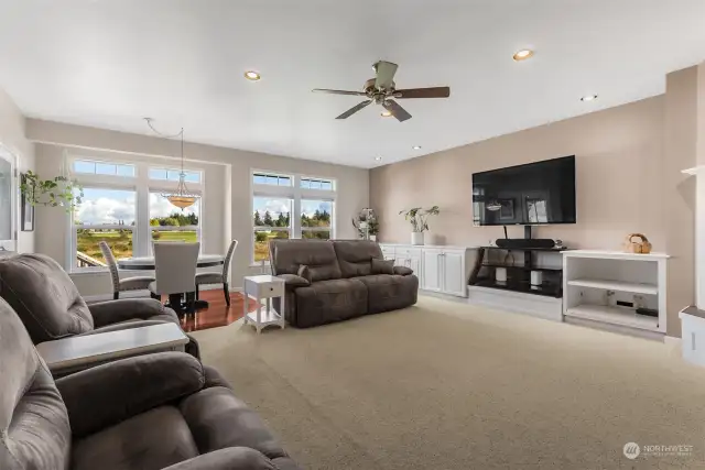 Ready for a daily dose of awe? This family room flaunts built-ins for all your storage needs while framing jaw-dropping views of Mt. Rainier through not one, but two stunning sets of windows. The casual dining area peeks into the scene, making this space  perfect for entertaining or family gatherings. It’s not just a room; it’s a front-row seat to nature’s best performance!